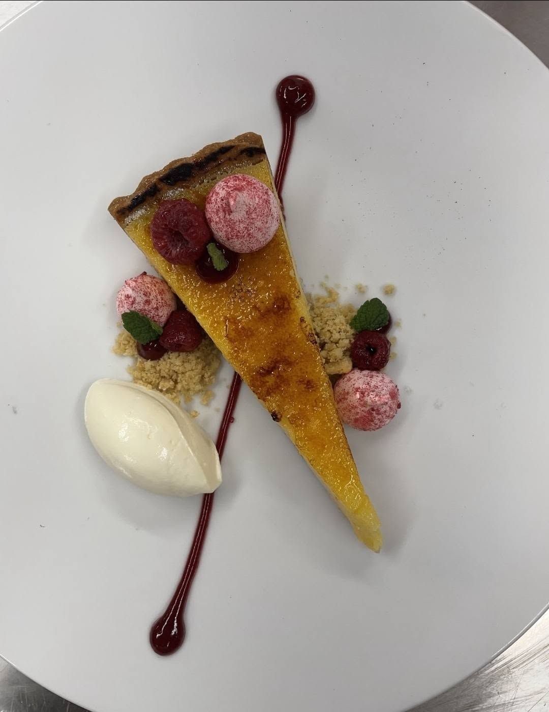 Torched lemon curd tart with raspberries and clotted cream