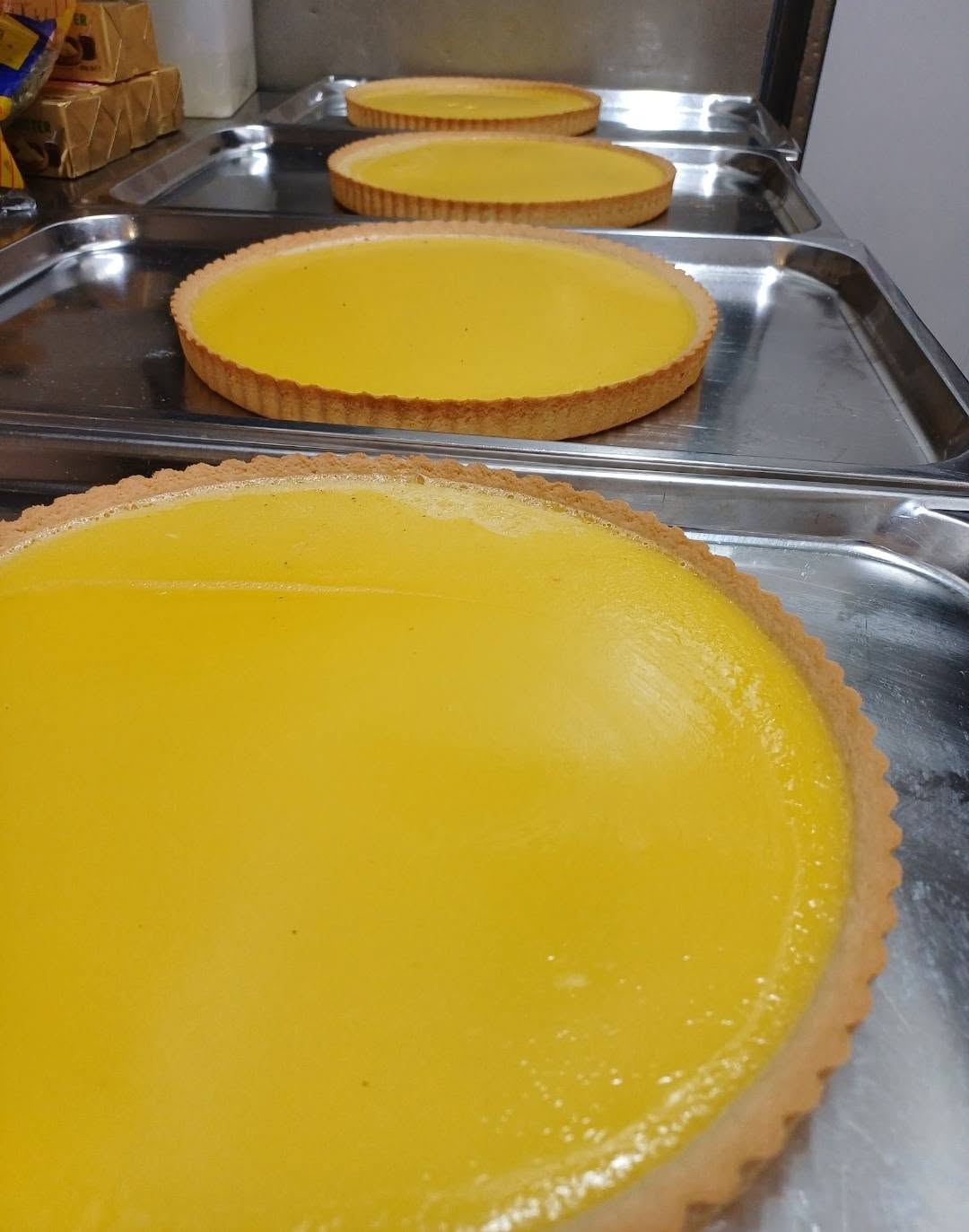 Lemon curd tarts cooling in the pastry kitchen